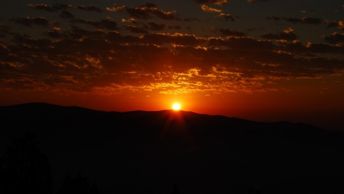 Sunset over mountains with clouds