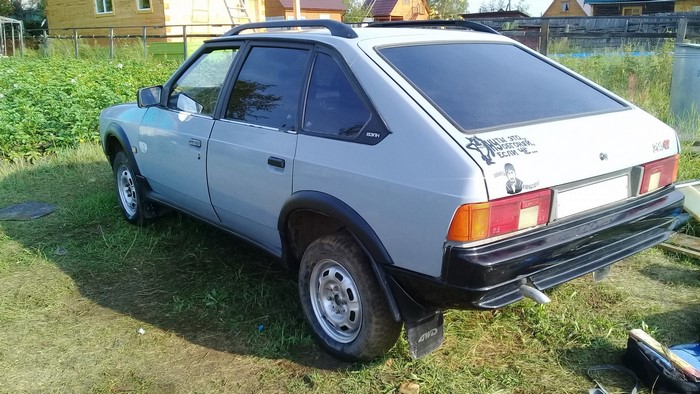 Moskvich car parked in a grassy yard