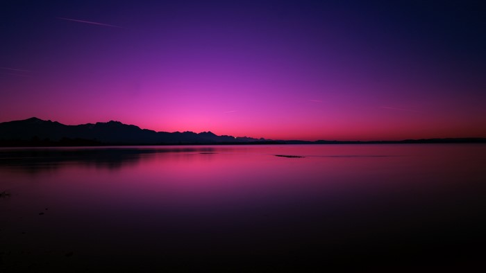 Purple Sunset Over Mountains and Lake