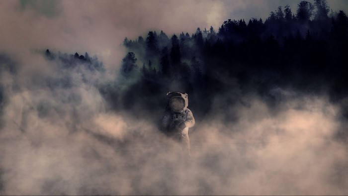 Astronaut in a foggy forest