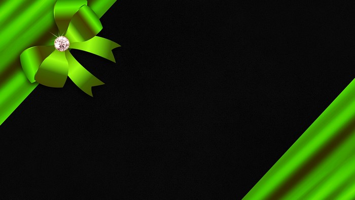 Green ribbon bow with diamond on black background
