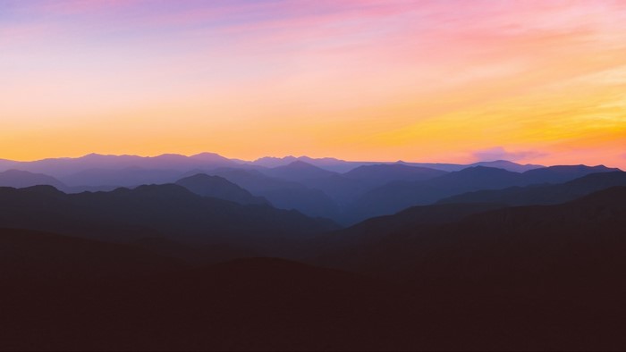 Layered mountains at sunset