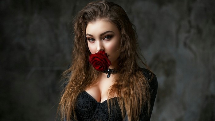 Woman with red rose and black corset