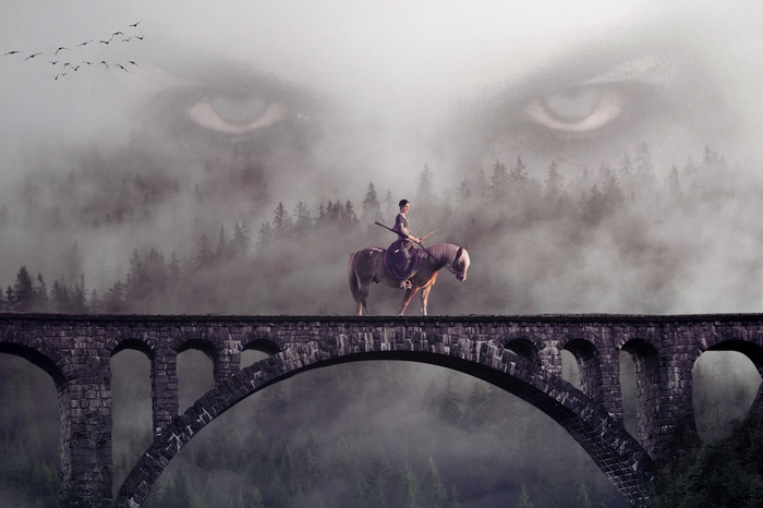 Rider on a bridge with giant eyes in the mist