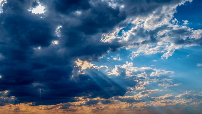 Sunbeams through dark clouds
