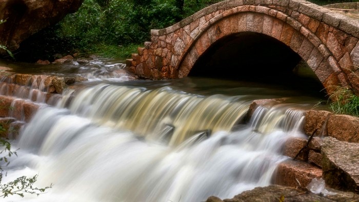 Stone bridge over a waterfall