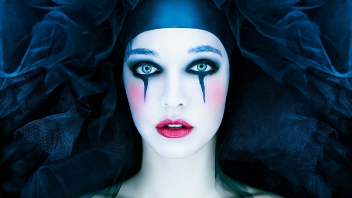 Woman with dramatic makeup and black veil