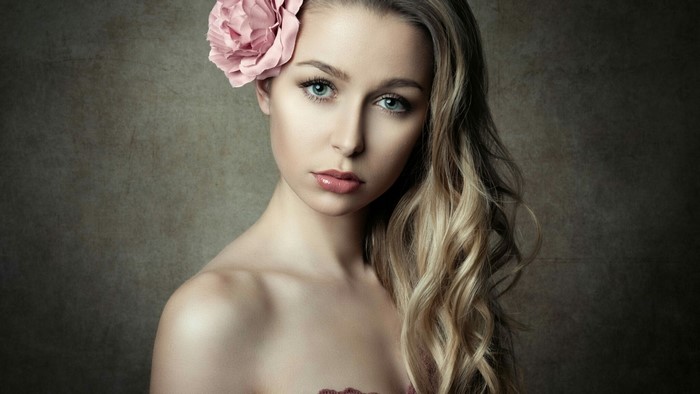 Young woman with a pink flower in her hair