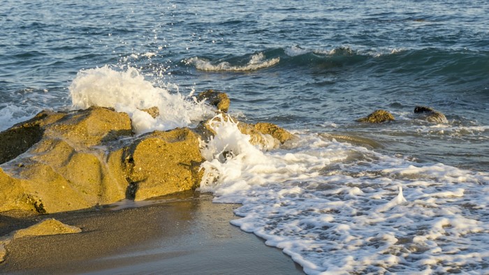 Waves crashing on rocks at the sea