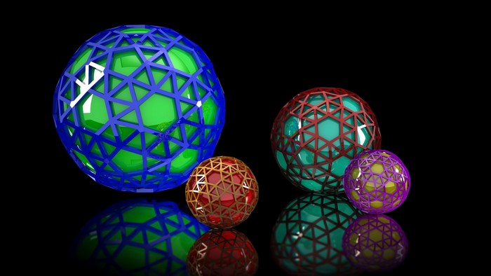 Four abstract geometric spheres on black background