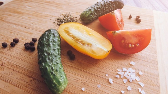 Still life with cucumbers, tomatoes, and spices