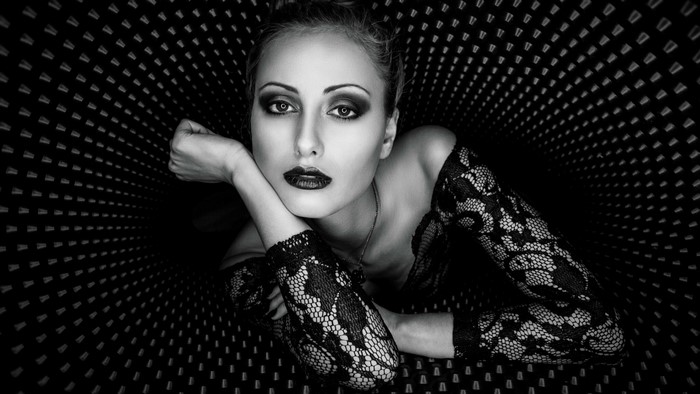Woman with dark makeup and lace top