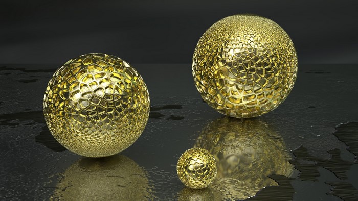 Three golden spheres with intricate patterns on a dark reflective surface