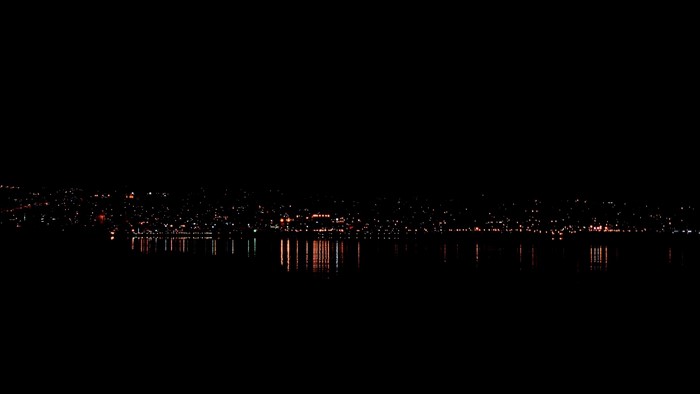 City lights reflecting on water at night