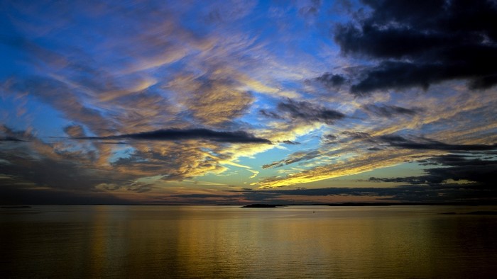 Sunset over the ocean with dramatic clouds