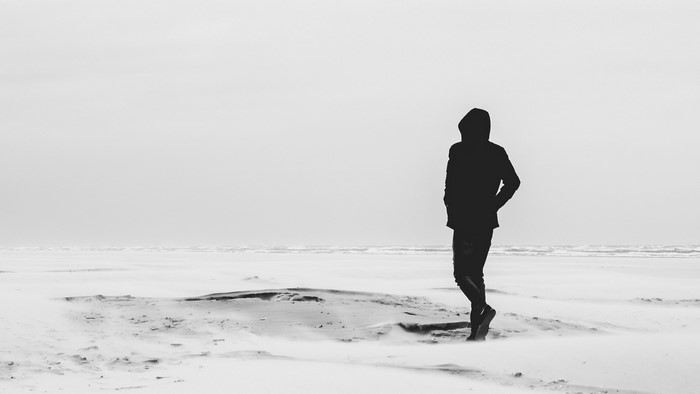 Silhouette of a person on a snowy beach