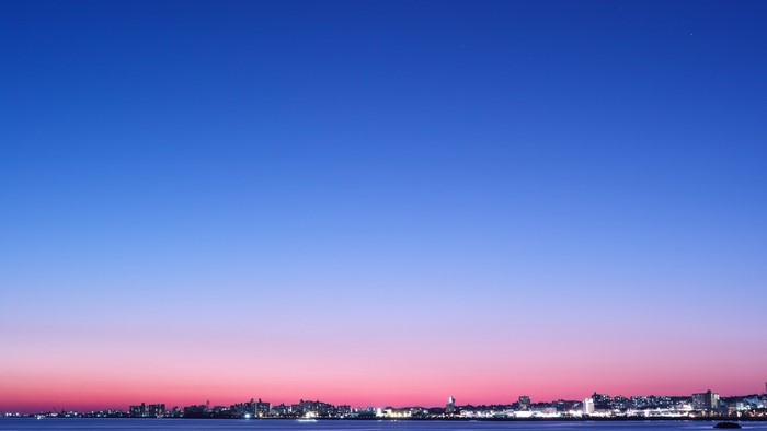 Cityscape at dusk over the ocean