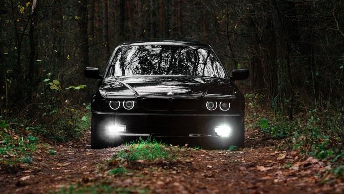 Black BMW E36 in a forest