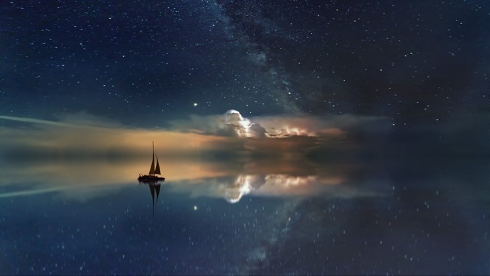 Sailboat under a starry sky with Milky Way