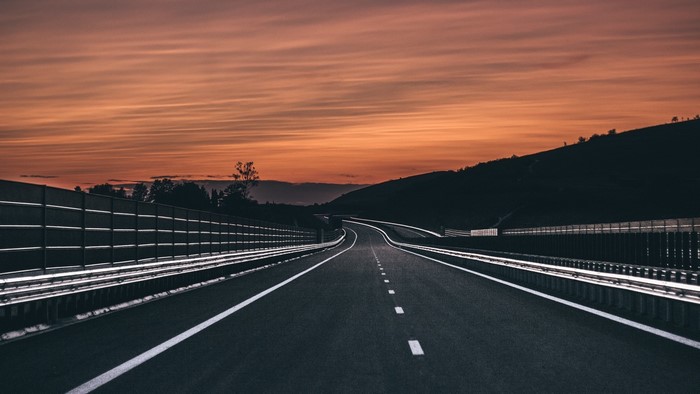 Empty highway at sunset