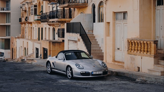 Silver Porsche Boxster parked on a street