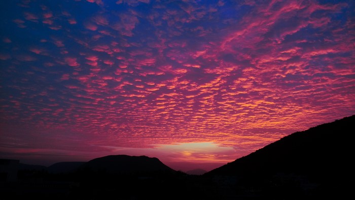 4K Sunset Clouds Over Silhouetted Hills