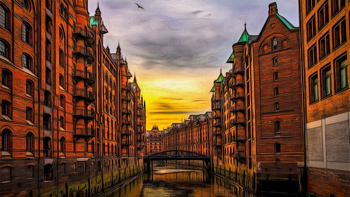 Warehouses and canal in Hamburg at sunset