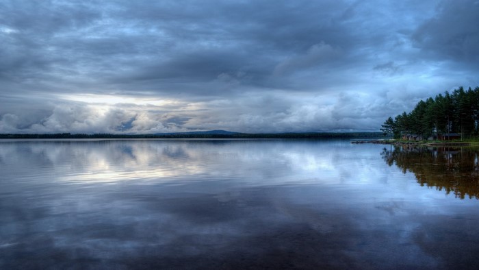 Lake with stormy clouds and trees