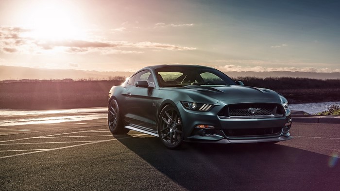 Ford Mustang GT parked by a body of water at sunset