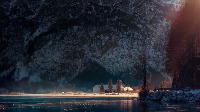 Snowy mountains and lake with a building in Austria