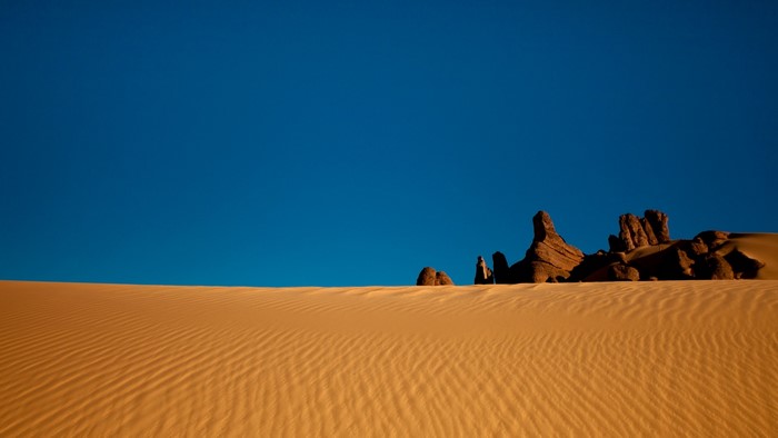Desert landscape with sand dunes and rock formations