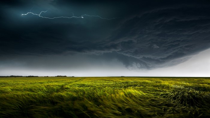 Stormy sky over a green field