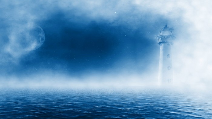 Lighthouse in Foggy Ocean at Night
