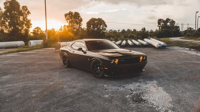 Black Dodge Challenger R/T parked at sunset