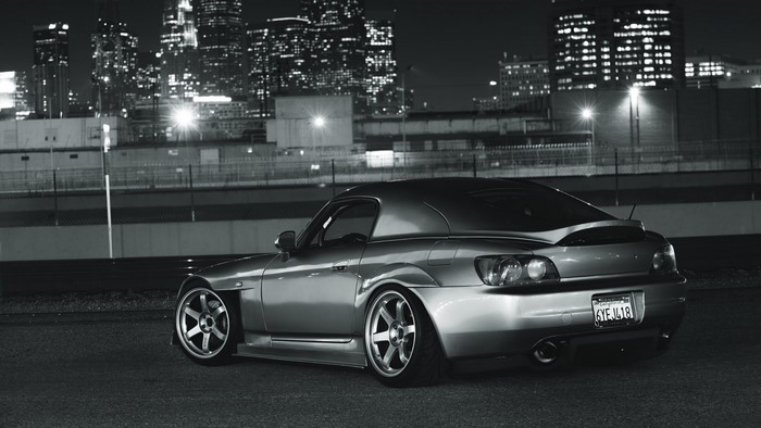 Honda S2000 at night with city skyline