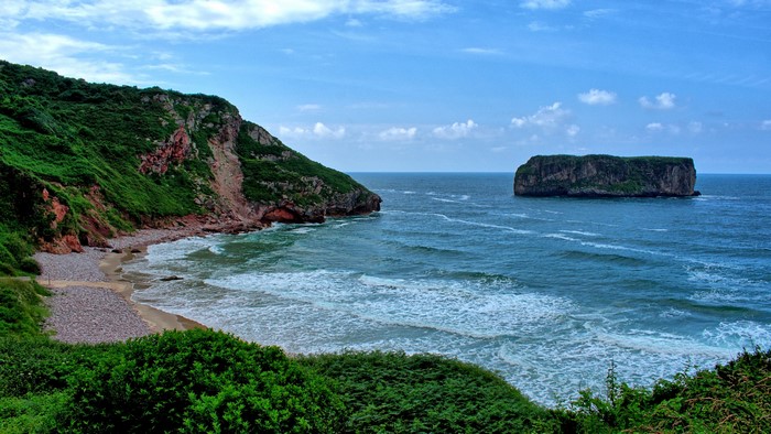 Rocky coastline with island in the sea