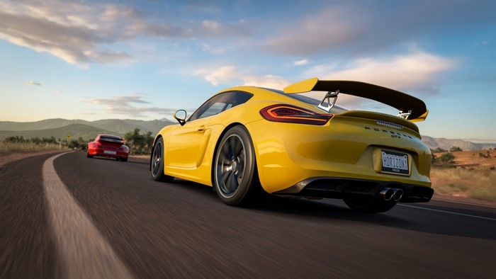 Yellow Porsche GT4 and red Porsche racing on a road in Forza Horizon 3