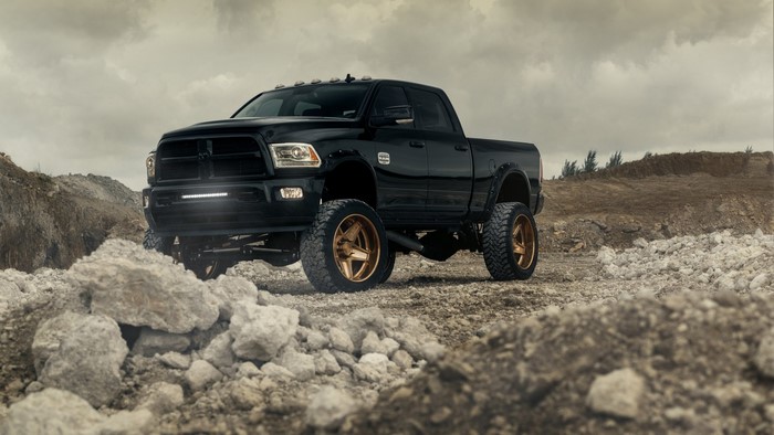 Black Dodge Ram 2500 truck with custom wheels