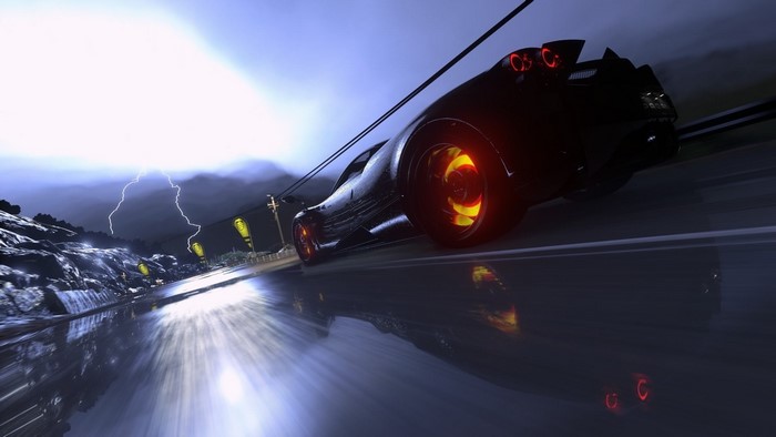 Black sports car on a wet road during a thunderstorm