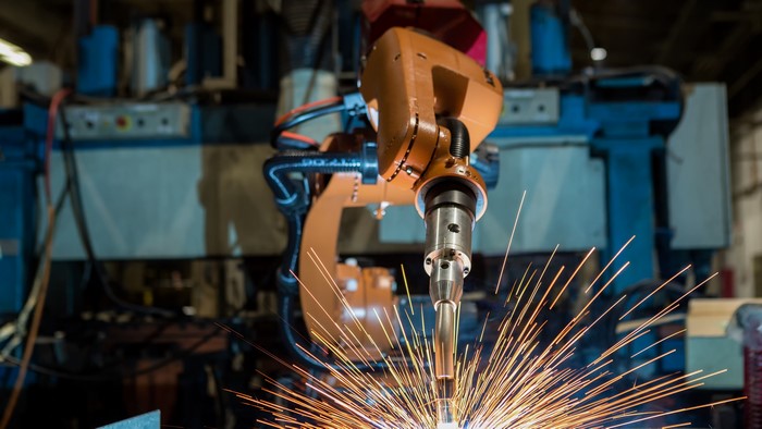 Robotic arm performing welding in a factory