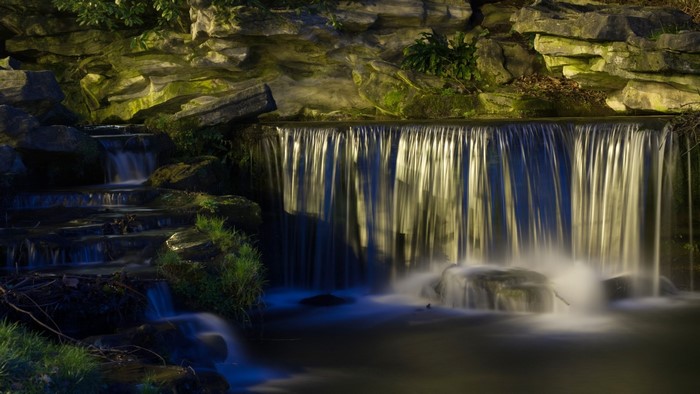 Waterfall cascading over rocks at night