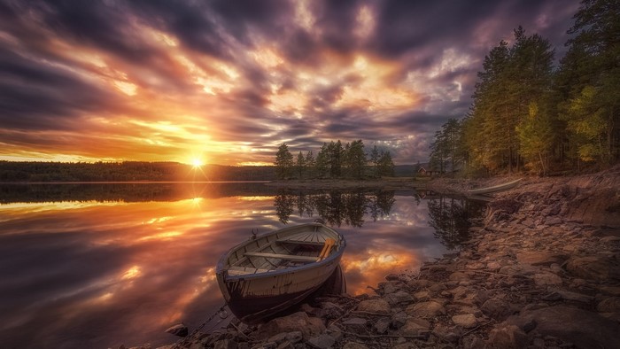 Boat on a lake at sunset in Ringerike, Norway