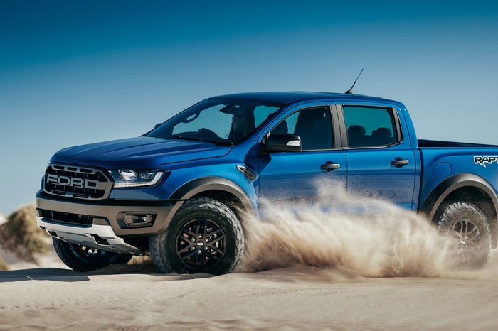 Blue 2019 Ford Ranger Raptor driving on sand