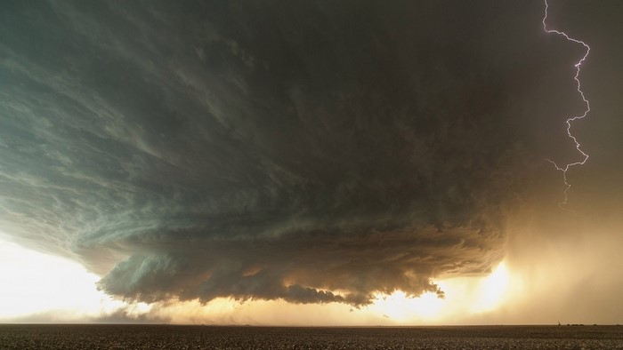 Storm over a field with lightning