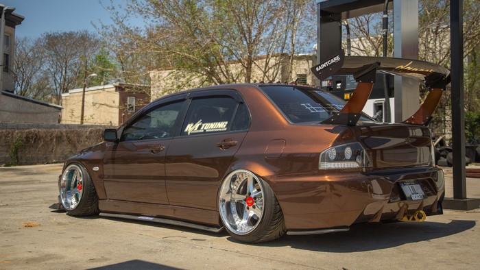 Brown Mitsubishi Lancer Evolution with large spoiler