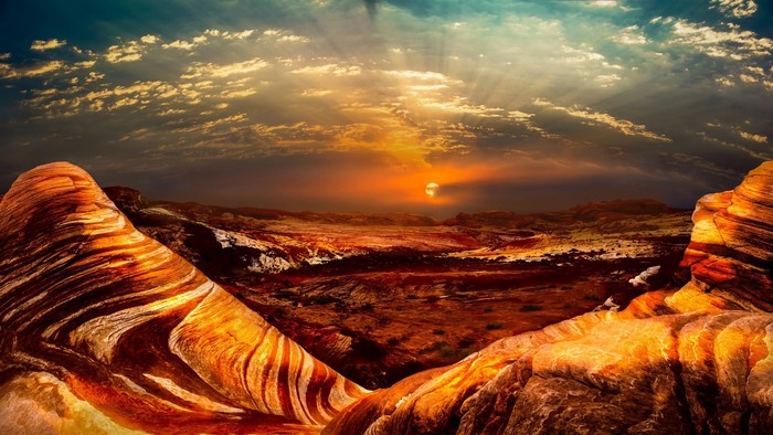 Sunset over a desert landscape with rock formations