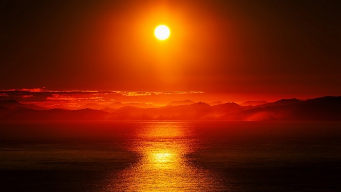Sunset over mountains and ocean