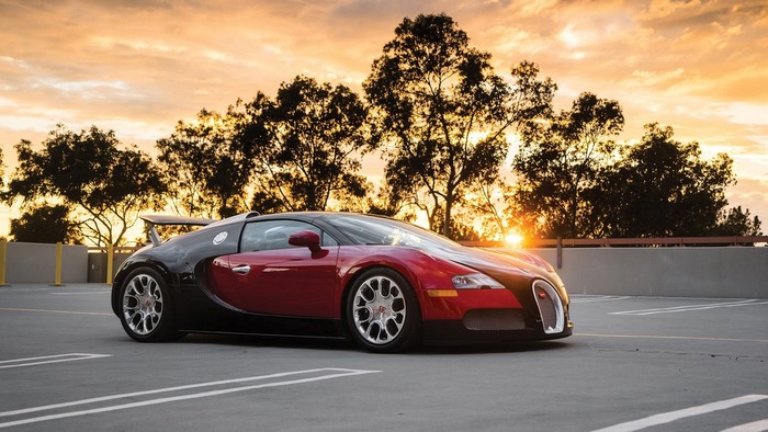 Bugatti Veyron in a parking lot at sunset