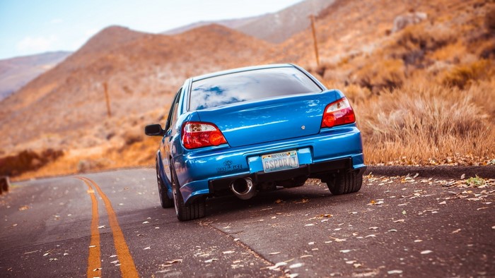 Blue Subaru Impreza on a Mountain Road