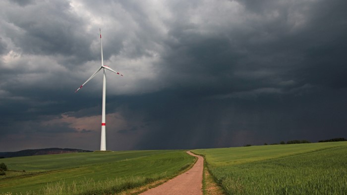 4K Windmill under stormy sky